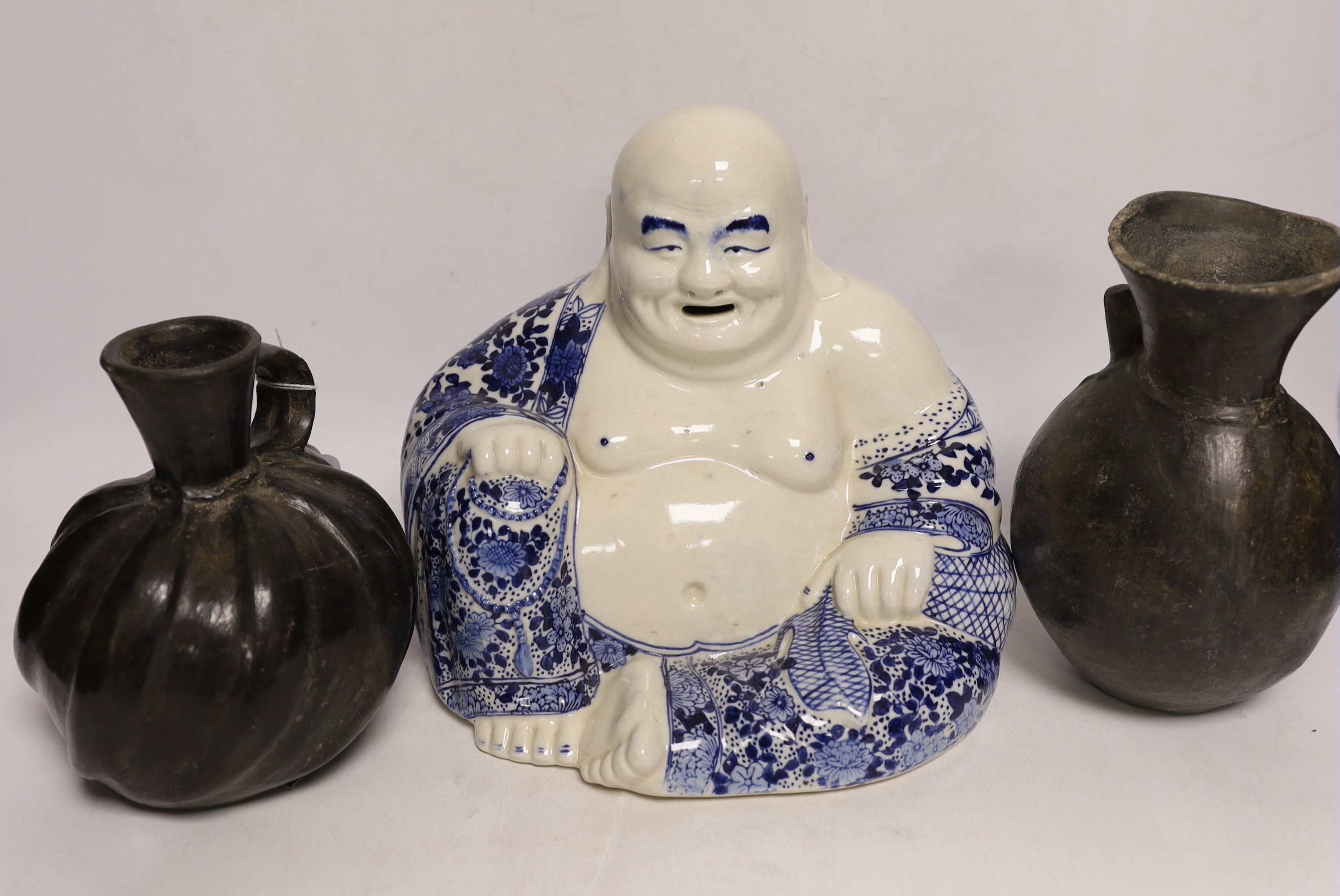 A Chinese blue and white buddha, 21cm, a famille rose dish and bowl and two vessels